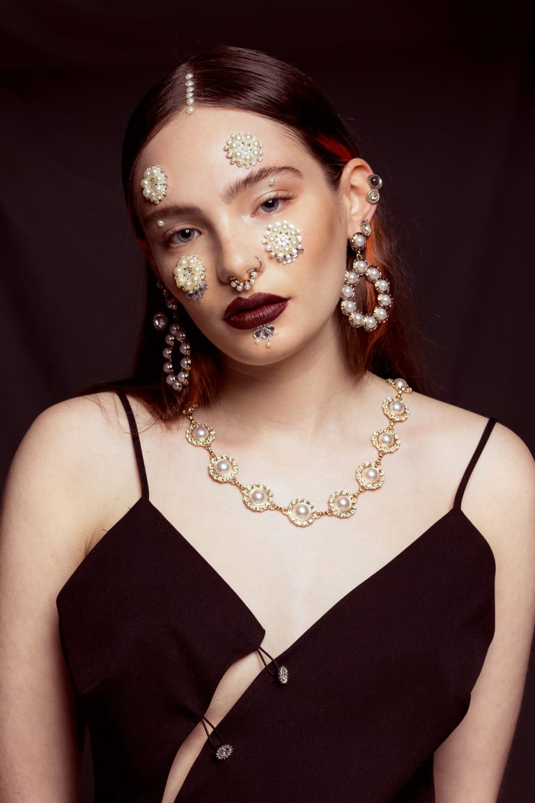 Model wearing elegant pearl jewellery, showcasing a sophisticated and stylish look. Baroque beauty fashion shoot.