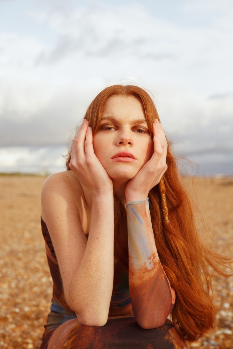 Beautiful model posing in a winter fashion shoot by Brighton seafront.