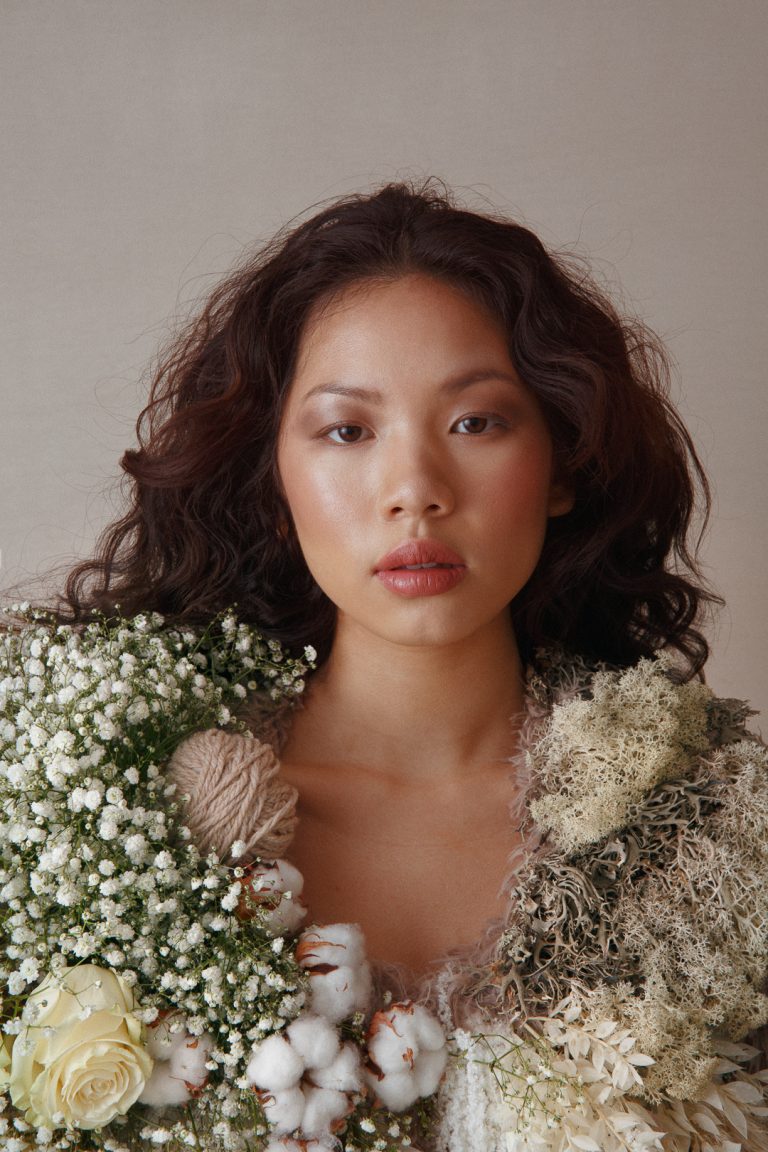 Model wearing a jacket made of flowers and textures