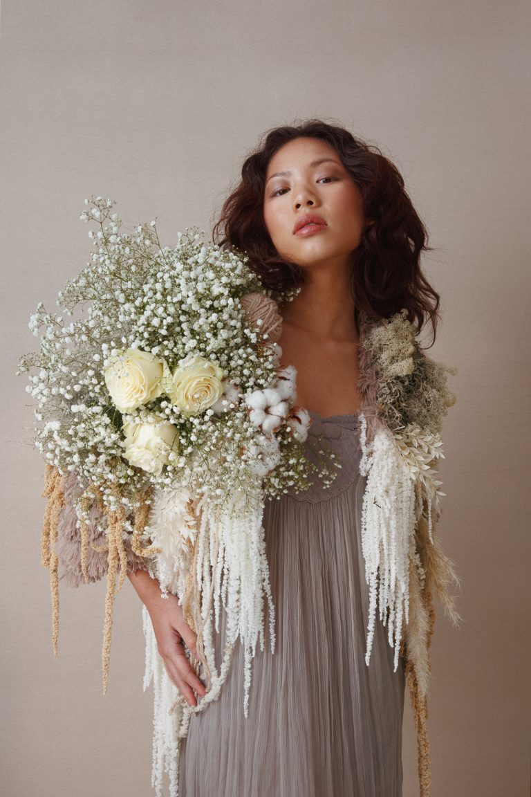 Model wearing a jacket made of flowers and textures