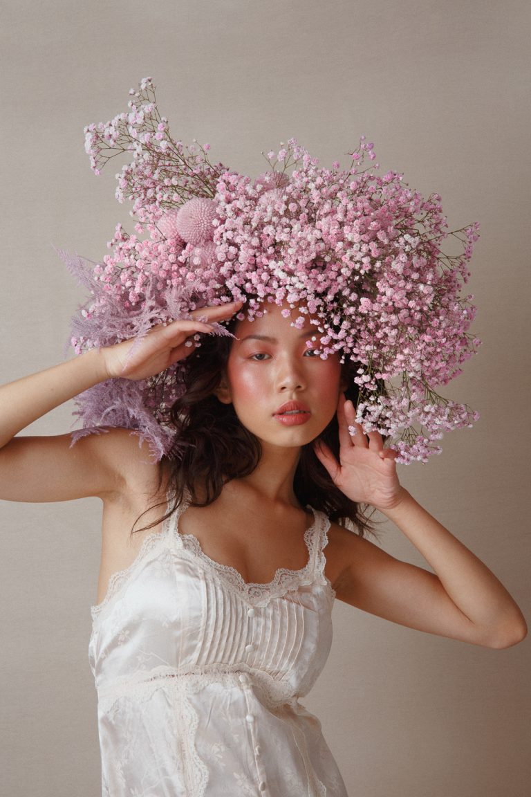 Model wearing a wig made of flowers