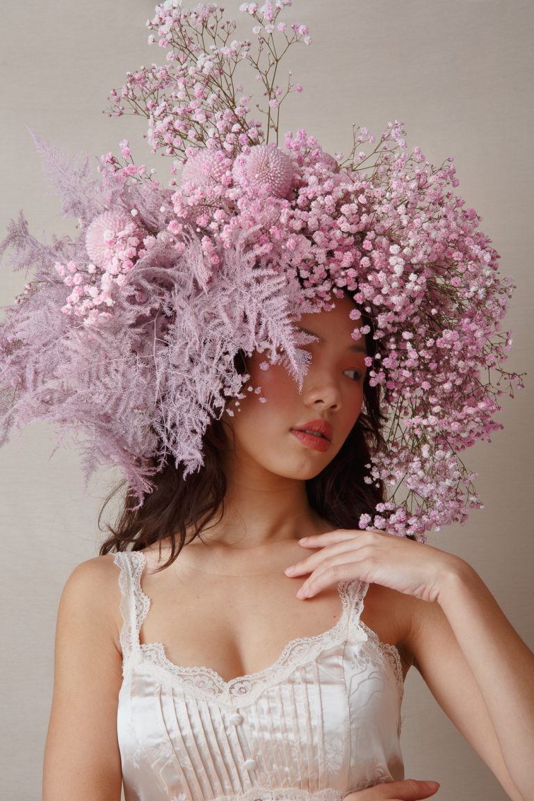 Model wearing a wig made of flowers