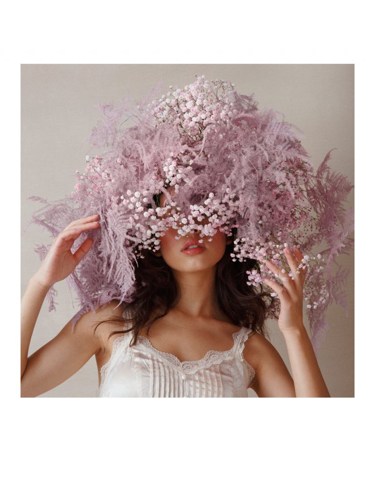 Model wearing a wig of pink flowers