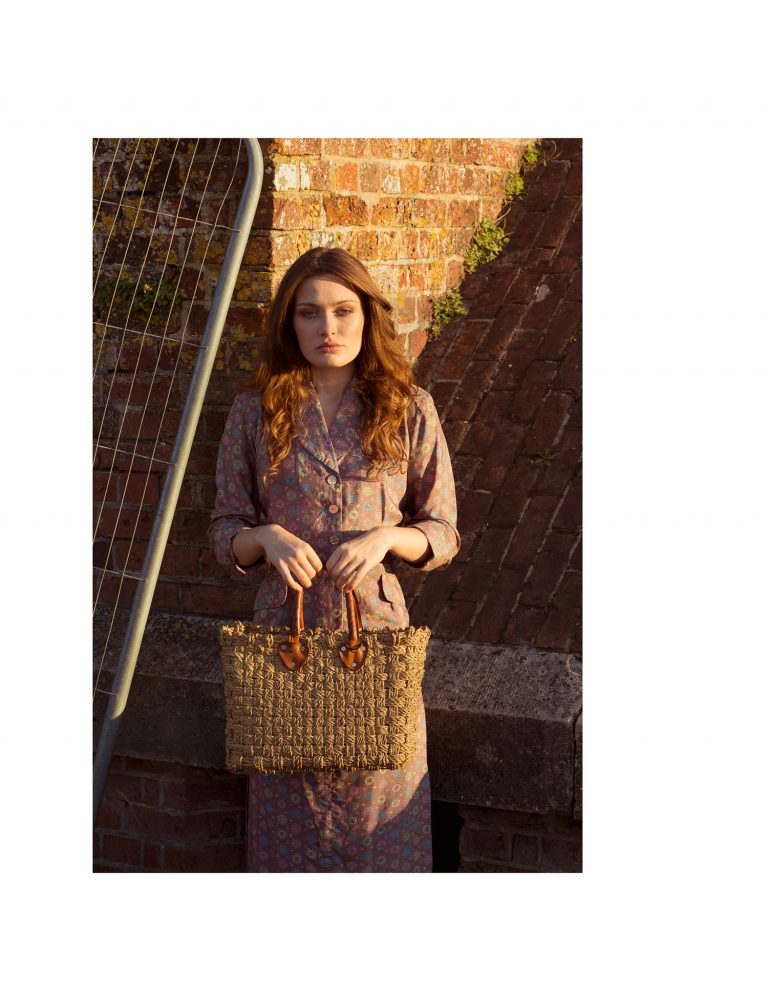 A female model holding a woven basket.
